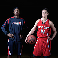 Male soccer player and female basketball player posing
