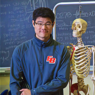 Professor stands with skeleton