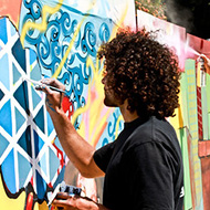 Male student paints a mural